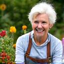 A joyful woman tending to her garden.